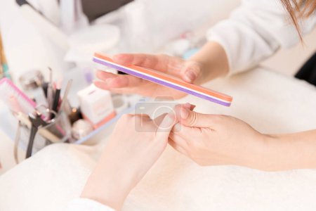 Photo for Woman making manicure in beauty salon. close up view of female hands - Royalty Free Image