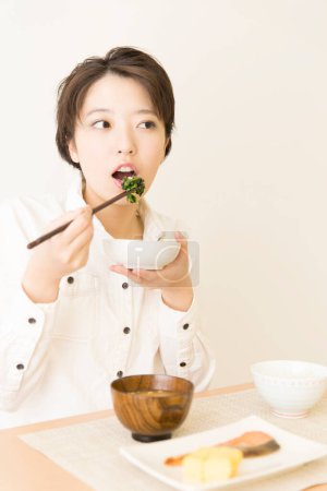 Photo for Beautiful  Japanese woman having a lunch at home - Royalty Free Image
