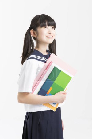 Foto de Retrato de hermosa joven estudiante en uniforme escolar - Imagen libre de derechos