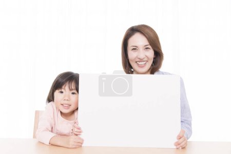 Photo for Mother and daughter with blank sign - Royalty Free Image