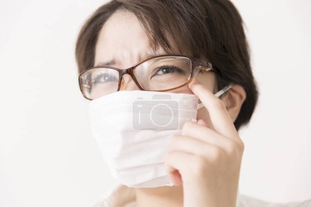Photo for Sick Asian woman wearing protective mask - Royalty Free Image