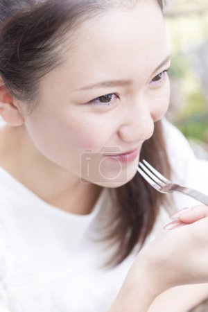 Photo for Woman having meal in restaurant - Royalty Free Image