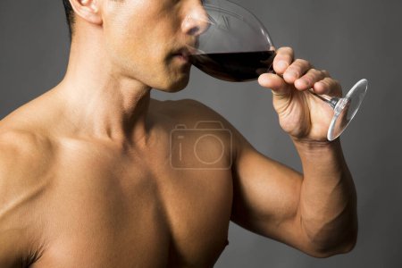 Photo for Portrait of man with muscular body holding glass of wine - Royalty Free Image