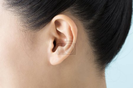 woman ear close up on background