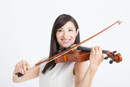 Photo for Smiling young beautiful asian woman playing violin  isolated on white background - Royalty Free Image