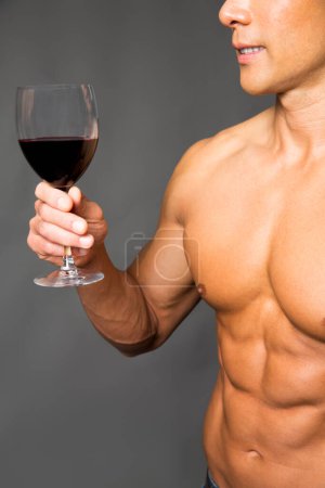 Photo for Portrait of man with muscular body holding glass of wine - Royalty Free Image