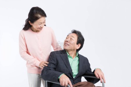 Photo for Happy asian senior woman  and man in Wheelchair - Royalty Free Image