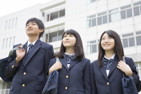 Photo for Portrait of young japanese students with bags in school - Royalty Free Image