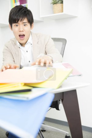 Photo for Shocked asian businessman at work - Royalty Free Image