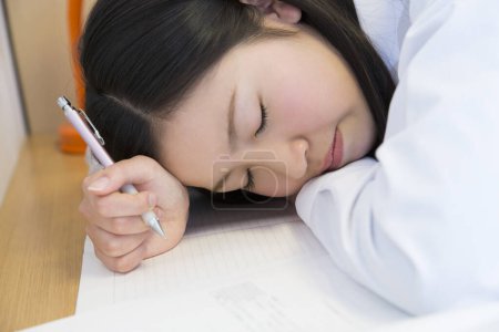Photo for Asian woman sleeping on the desk - Royalty Free Image