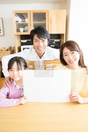 family of three  with card at home 
