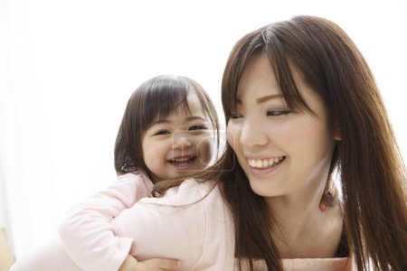 Photo for Asian mother and daughter playing together - Royalty Free Image