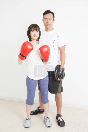 Photo for Portrait of young japanese woman boxer with coach training together - Royalty Free Image