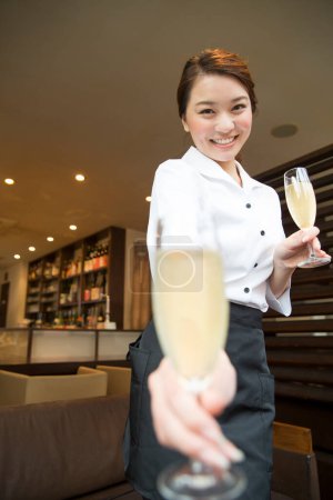Photo for Waitress with glasses of wine in restaurant - Royalty Free Image