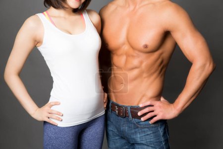 Photo for Fitness and health concept. Studio portrait of sporty japanese man and woman - Royalty Free Image