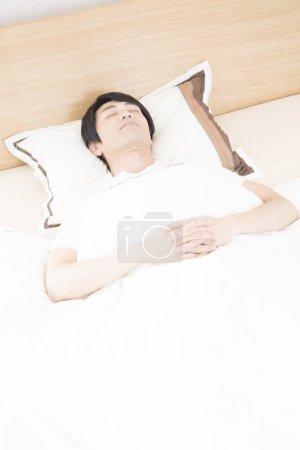 Photo for Asian man sleeping in bed. - Royalty Free Image