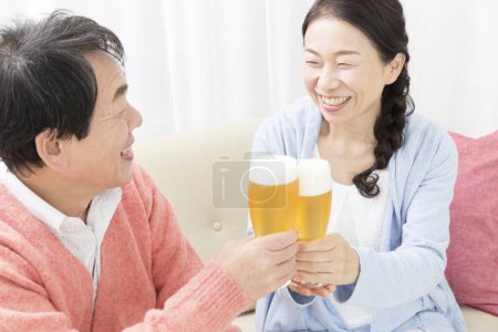 Photo for Asian couple with glasses of beer - Royalty Free Image