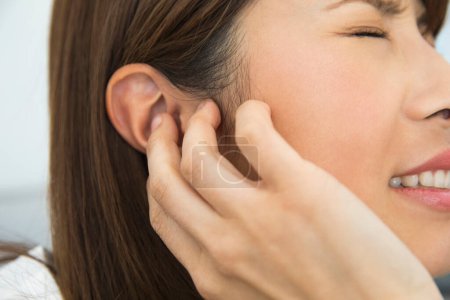 Photo for Woman with ache in ear of a young woman - Royalty Free Image