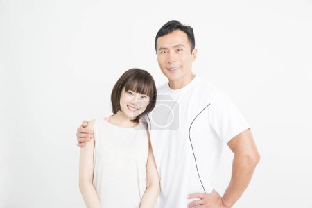 Photo for Fitness and health concept. Studio portrait of sporty japanese man and woman - Royalty Free Image