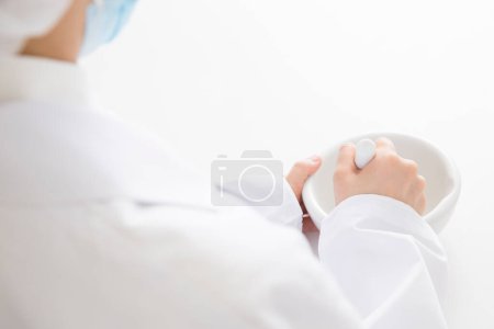 woman in medical mask grinding pills