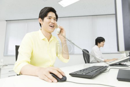 Photo for Asian businessman working at desk - Royalty Free Image