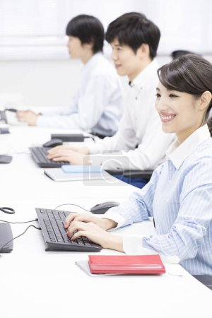 Photo for Young business people working on computers in office - Royalty Free Image