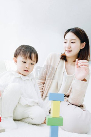 Photo for Cute Japanese girl playing with mother at home - Royalty Free Image