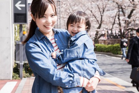 Photo for Portrait of cute Japanese child with mother outdoors - Royalty Free Image