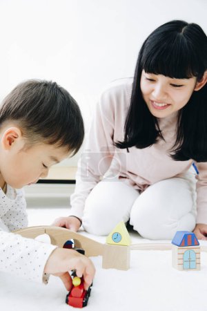 Photo for Cute Japanese boy playing with mother at home - Royalty Free Image