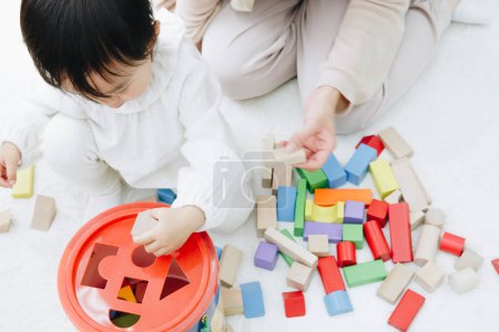 Photo for Cute Japanese girl playing with mother at home - Royalty Free Image