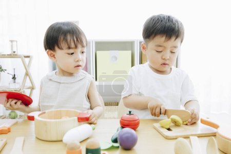 Photo for Cute Japanese children playing with toys at home - Royalty Free Image