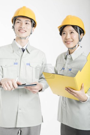 Photo for Studio portrait of Asian male and female construction engineers - Royalty Free Image