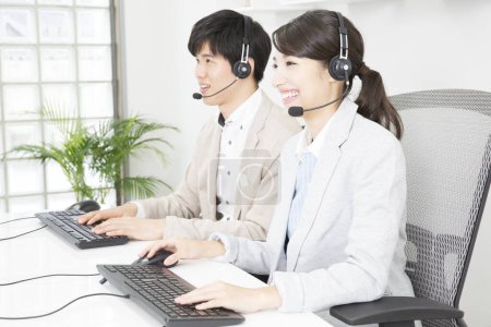 Photo for Asian business people  with headsets - Royalty Free Image