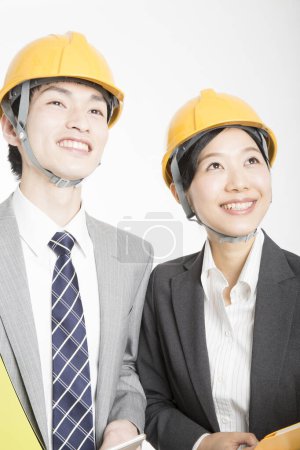 Photo for Studio portrait of Asian male and female construction engineers - Royalty Free Image
