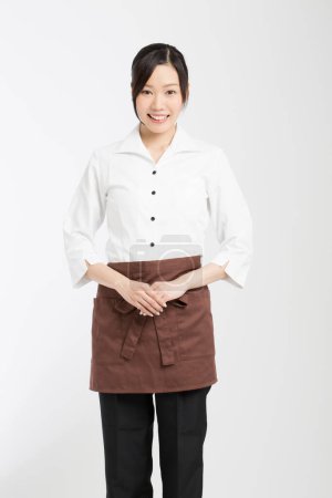 Photo for Asian female waitress in  apron isolated on white background - Royalty Free Image