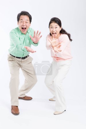 Foto de Asiático senior pareja haciendo monstruos mandíbulas gesto estudio disparo - Imagen libre de derechos