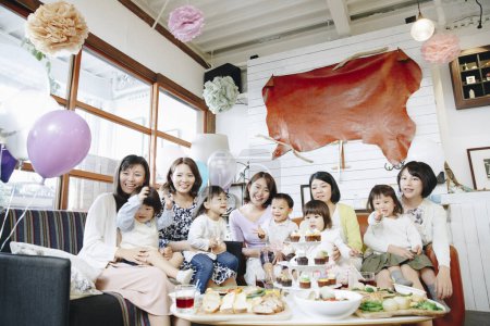 Photo for Happy Japanese women with children celebrating together. - Royalty Free Image