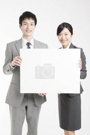 Photo for Business people holding a blank sign - Royalty Free Image