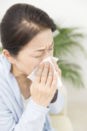 Photo for Asian woman having flu and blowing nose - Royalty Free Image