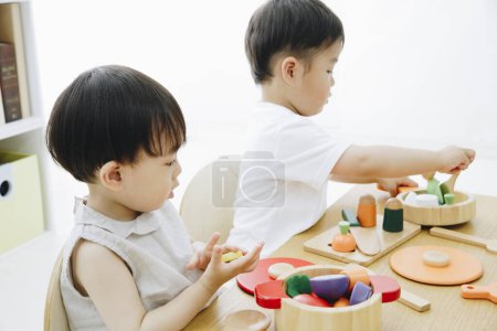 Photo for Cute Japanese children playing with toys at home - Royalty Free Image