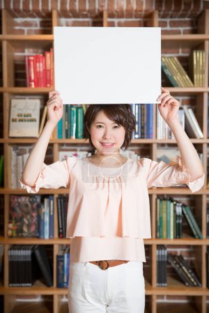 Photo for Young asian woman with a blank sign - Royalty Free Image