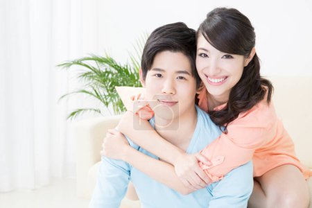 Photo for Young happy  asian family at home - Royalty Free Image