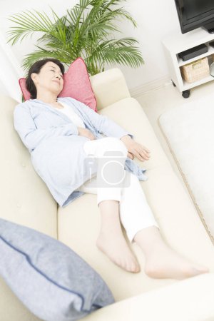 Photo for Asian woman sleeping on the sofa - Royalty Free Image