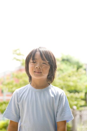 Photo for Portrait of young Japanese boy in summer park - Royalty Free Image