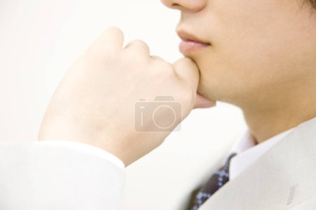 Photo for Portrait of a businessman wit hand on chin - Royalty Free Image