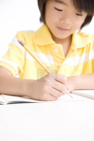Photo for Asian boy studying on white background - Royalty Free Image