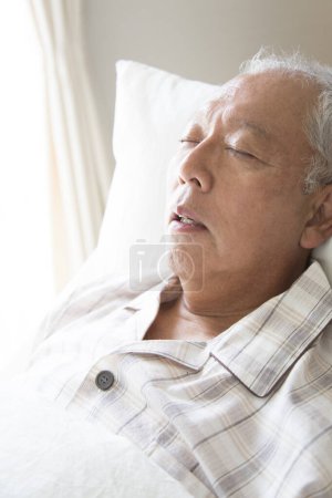 Photo for Asian senior man sleeping on bed - Royalty Free Image