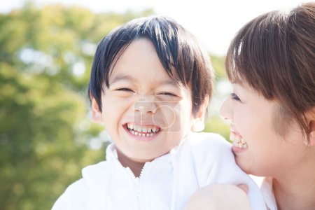 Photo for Close up outdoor portrait of asian mother and son having fun together - Royalty Free Image