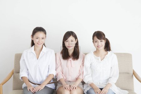 Photo for Portrait of three smiling young Japanese women - Royalty Free Image