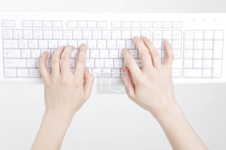 Photo for Female hands typing on white keyboard, close up view - Royalty Free Image